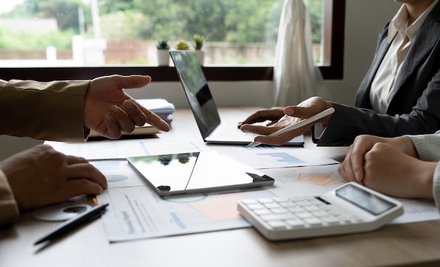 Business accounting team brainstorming data target financial on laptop calculator and paperwork