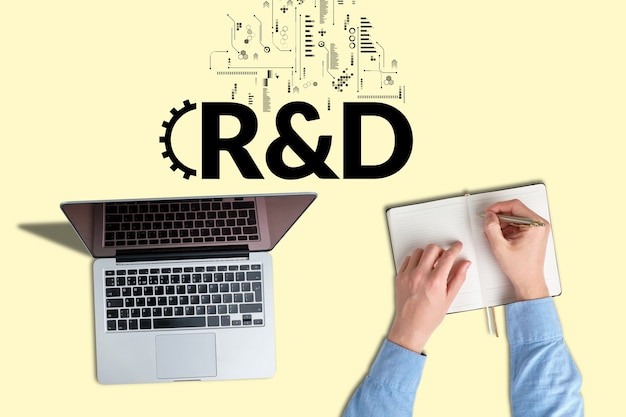 Business acronym rd or research and development person works and takes notes