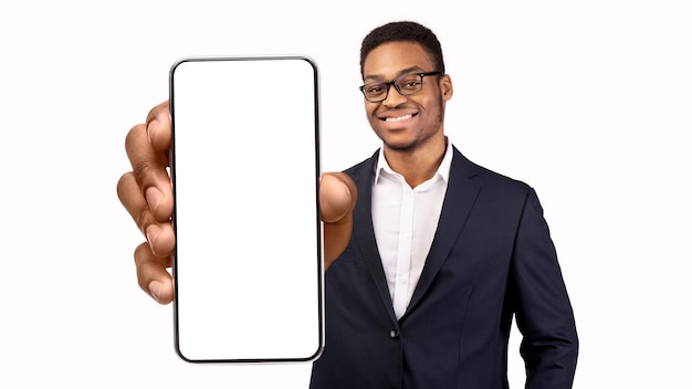 Business app black young businessman holding big blank smartphone in hand