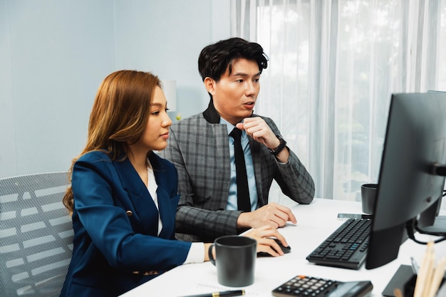 Business asian coworkers analyzing marketing project on computer infobahn