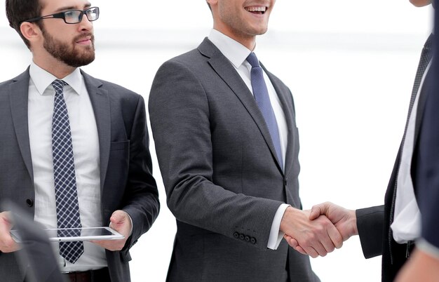 Business associates shaking hands in office