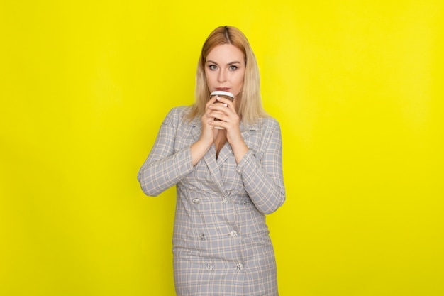 Business blonde woman with cup of coffee