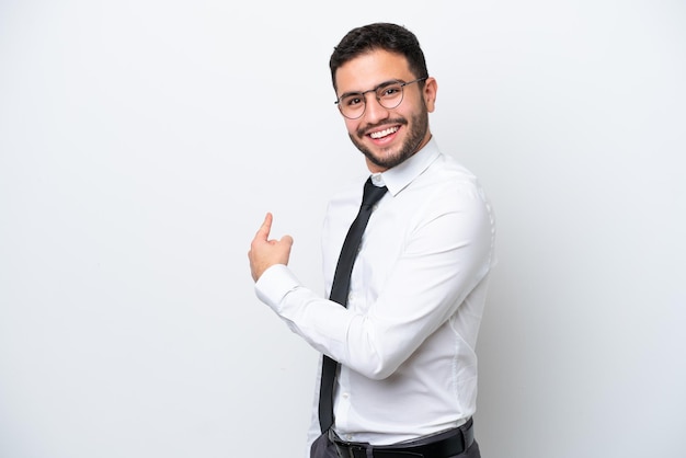 Business Brazilian man isolated on white background pointing back