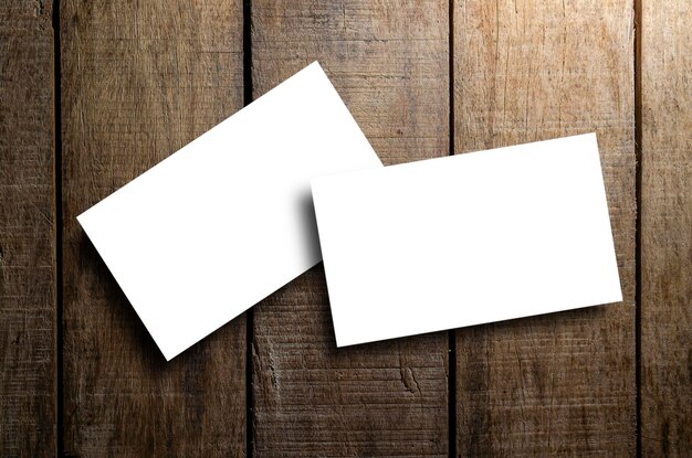 Business card blank on wooden texture background in still life and dark tone