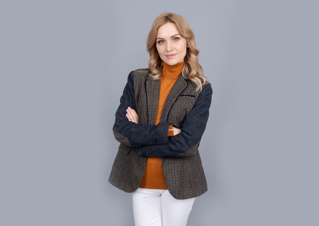 Business casual style girl in british jacket british fashion style smiling businesswoman in english clothes on grey background cheerful blonde woman in jacket female beauty and fashion