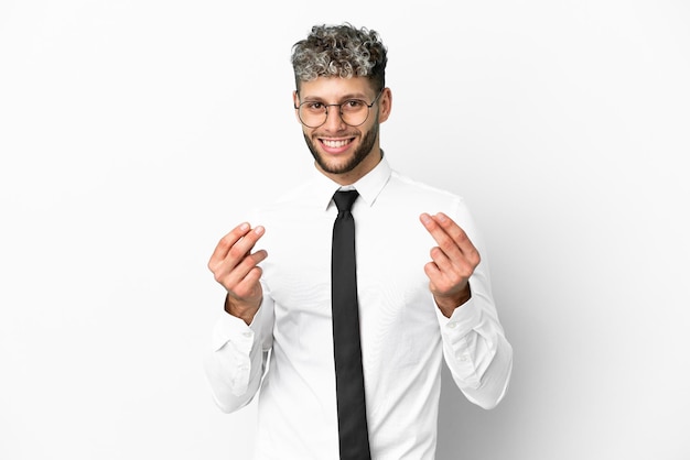 Business caucasian man isolated on white background making money gesture