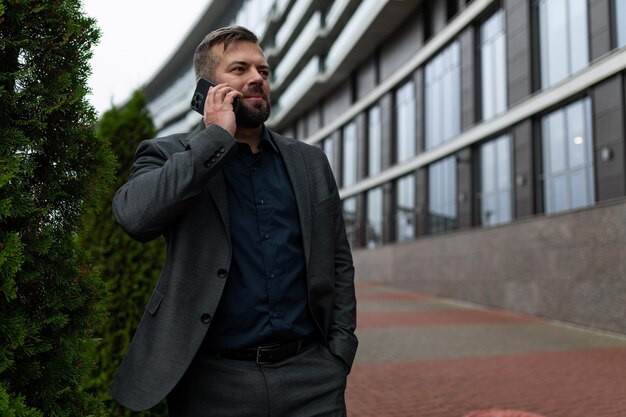 Business caucasian man talking on mobile phone outside