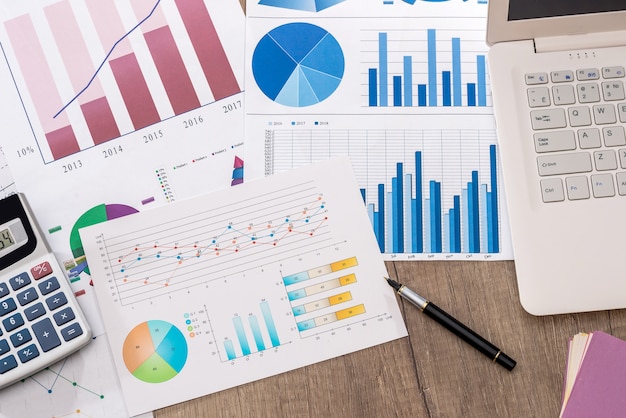 Business chart with calculator and laptop