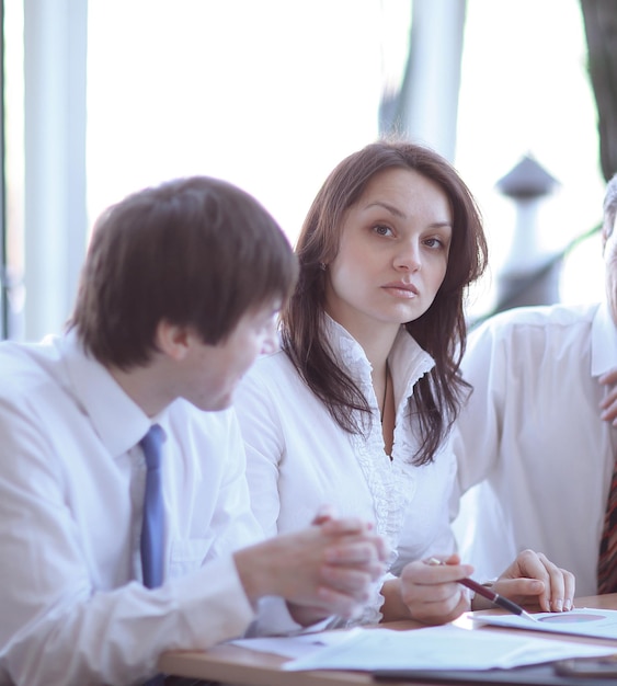 Business colleagues analyzing financial statistics sitting at a Desk