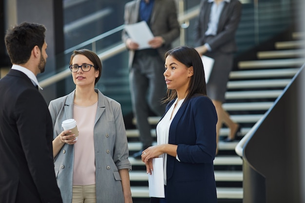 Business colleagues discussing project plan in lobby