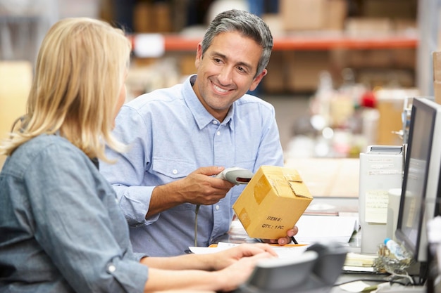 Business Colleagues Working At Desk In Warehouse