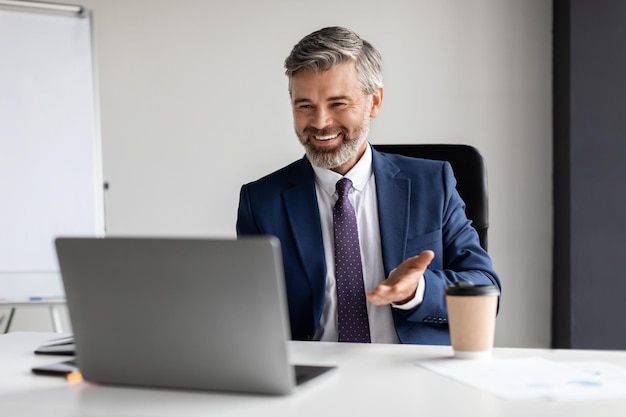 Business Communication Middle Aged Entrepreneur Making Video Call With Laptop In Office