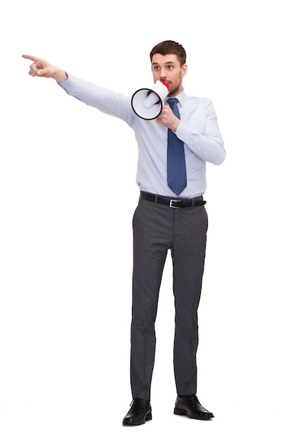 business, communication and office concept - angry businessman with megaphone showing direction with hand