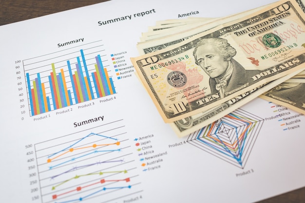 Business concept - American dollars banknote and graphs 