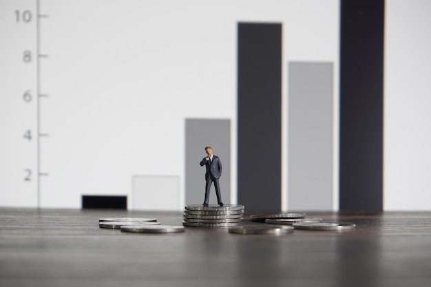 Business concept Businessman standing on a pile of silver coins