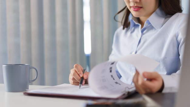 Business concept Businesswoman read financial data on document to analyze investment for project