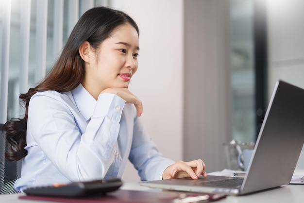 Business concept Businesswoman thoughtful about new project while reading marketing data on laptop