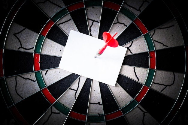 Business concept darts arrows in the target center with paper note for Writing goals for this business year