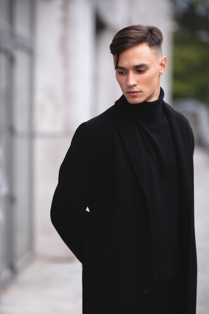 Business concept. The guy walks down the street against the backdrop of skyscrapers