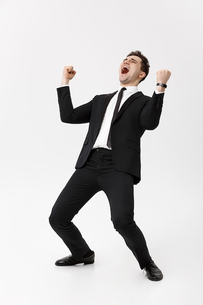 Business Concept - Handsome cheerful businessman showing hands in air over gray background.