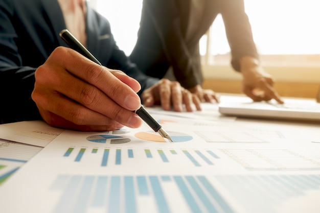 Business concept. Rows of coins for finance and banking concept with business man and woman. A metaphor of international financial consulting.