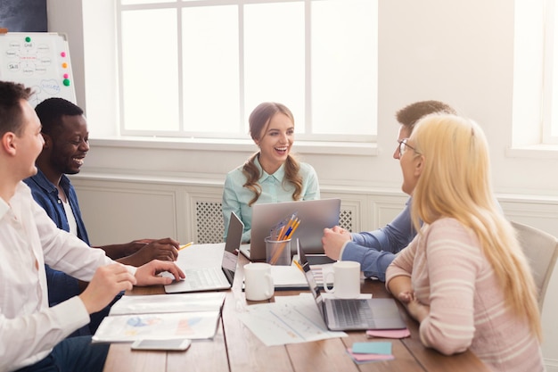 Business corporate meeting of young successful team with female boss. Office discussion, communication with partners, copy space