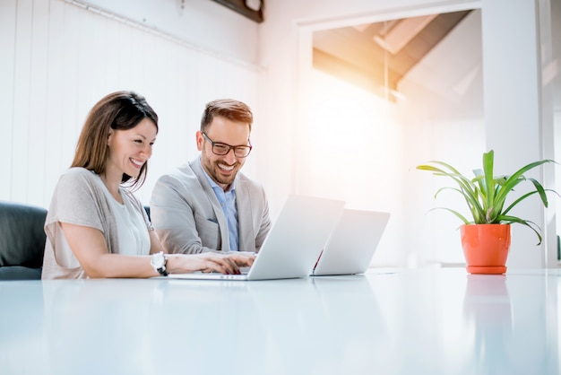 Business couple working together on project at modern startup office.