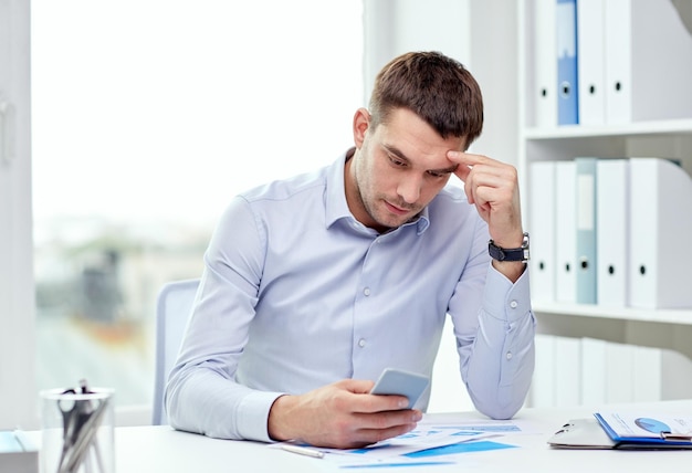 business, deadline, people and technology concept - close up of businessman with smartphone