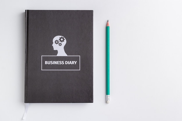 business diary and pencil on white background isolated