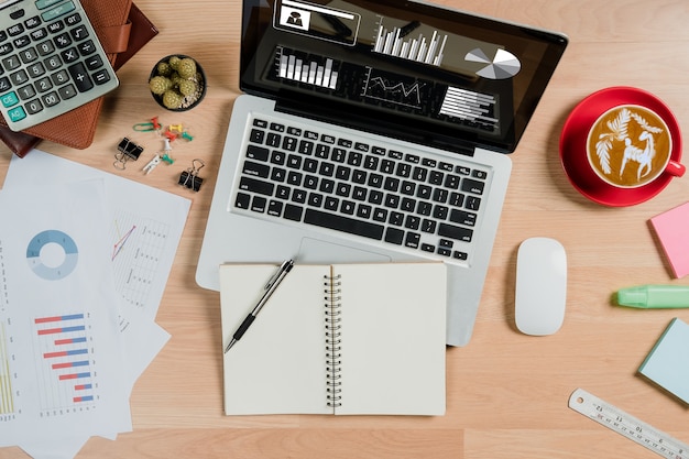 Business document Financial chart and graph on desk table.Top view office supply.