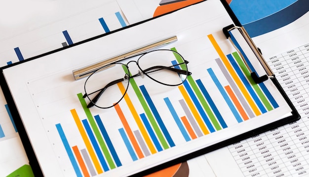 Business document Financial chart and graph with pen and glasses