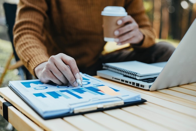 Business documents on office table with laptop and tablet and graph financial