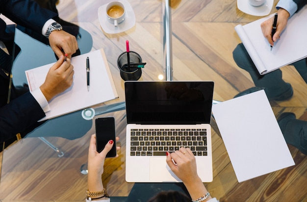 Business documents on office table with smartphone and laptop