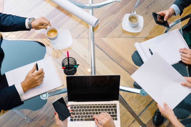 Business documents on office table with smartphone and laptop