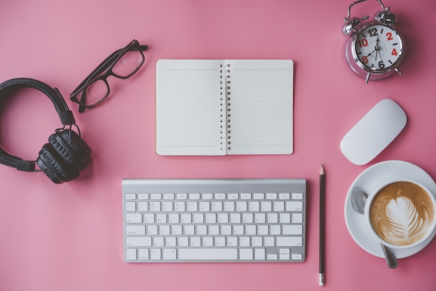 business, education concept. Office supplies, blank screen notebook on a pink table.