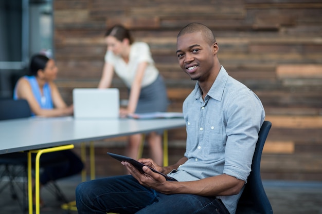 Business executive using digital tablet in office