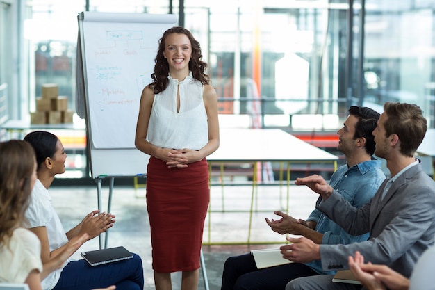 Business executives applauding after presentation