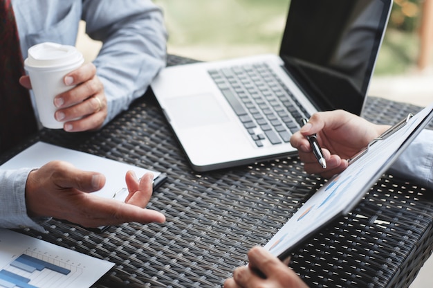 Business Executives discussing about profits at a modern outdoor workplace.