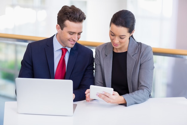 Business executives discussing over digital tablet