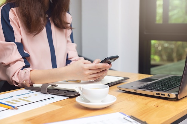 Business and finance concept, Businesswoman discussing sale analysis Chart in coffee shop