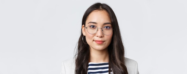 Business finance and employment female successful entrepreneurs concept Closeup of modern stylish asian businesswoman in glasses looking confident and determined at camera