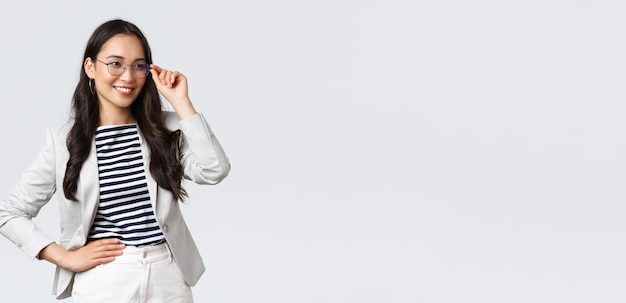 Business finance and employment female successful entrepreneurs concept Confident businesswoman in glasses and white suit ready for meeting smiling pleased standing determined