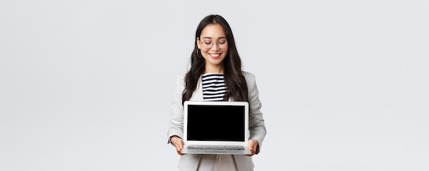 Business finance and employment female successful entrepreneurs concept Enthusiastic businesswoman in suit and glasses showing presentation demonstrate her project on laptop screen