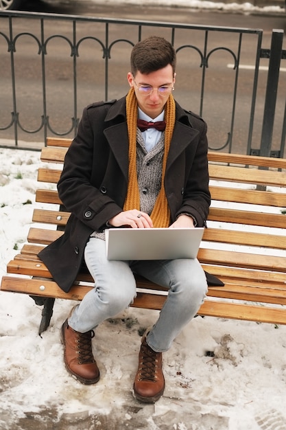 Business and freedom. Modern businessman, laptop keyboard with a laptop on a bench and working,