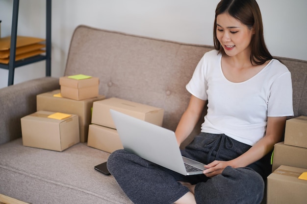 Business From Home Asian woman preparing package delivery box Shipping for shopping online young start up small business owner at home online order