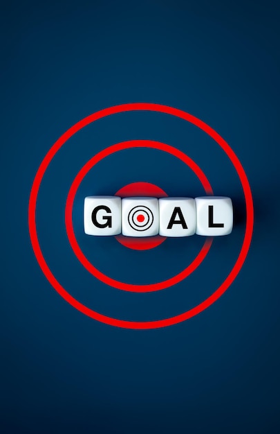 Photo business goals and success concept text goal on white cube blocks on with dart icon on big red target symbol on blue background vertical style working destination action plan objective banner