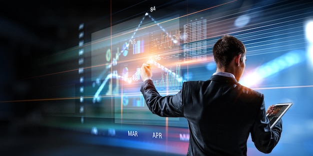 Business graph and trade monitor. Mixed media