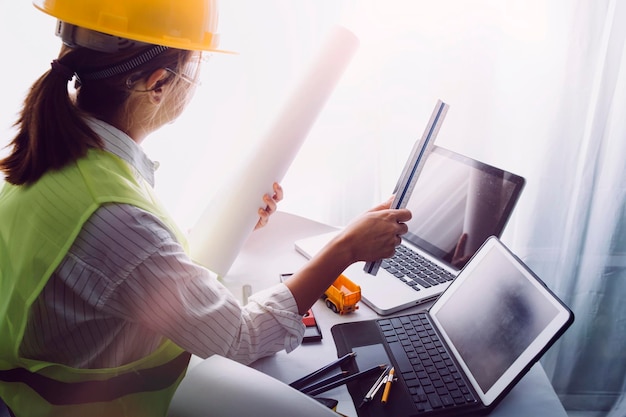 Business hand working and laptop with on on architectural project at construction site at office desk in office