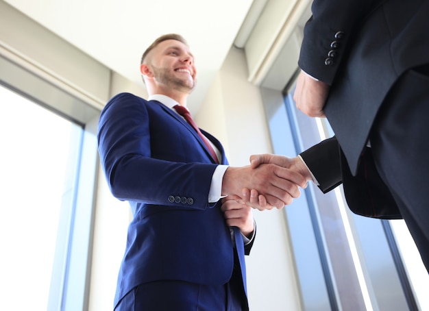 Photo business handshake. business man giving a handshake to close the deal