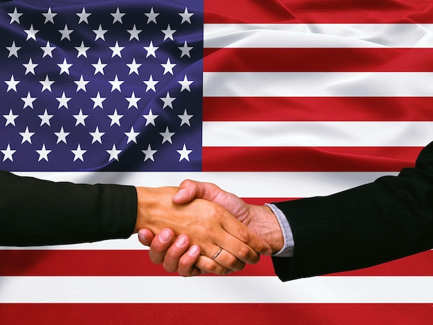 Business handshake on United State of America flag background